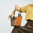 model-seated-plum-blossom-handbag-on-knees