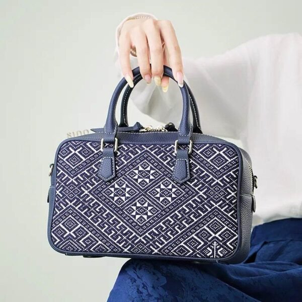 zhuang-brocade-flying-swallow-embroidered-leather-crossbody-bag-model-blue-dress-sitting-knee zhuang-brocade-flying-swallow-embroidered-leather-crossbody-bag-model-blue-dress-sitting-knee